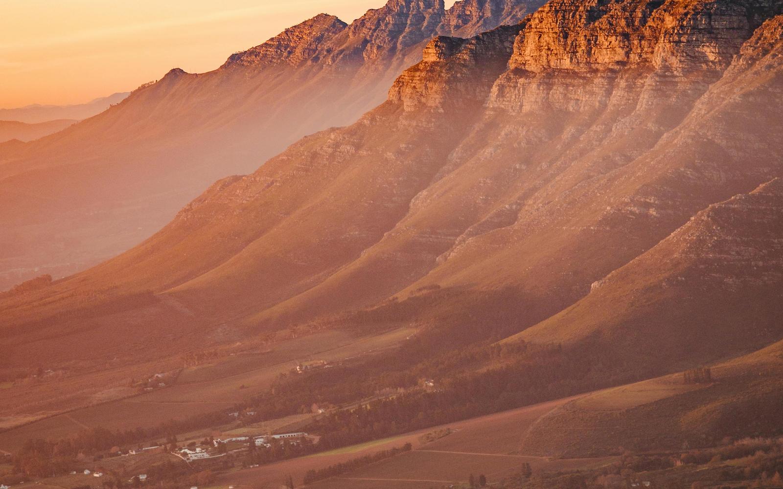 Stellenbosch winelands at sunset — vineyards beneath the mountains